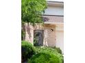 Close-up of the home's address above a brick front entrance with a security gate at 4034 S Atchison Way, Aurora, CO 80014