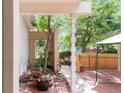 Outdoor patio area featuring a charming brick surface, wooden fence and garden area at 4034 S Atchison Way, Aurora, CO 80014