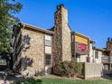 Rear view of the property showing a stone exterior and a private balcony at 7870 W 87Th Dr # L, Arvada, CO 80005