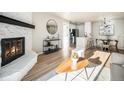 Bright living room featuring a stone fireplace and hardwood floors at 7870 W 87Th Dr # L, Arvada, CO 80005