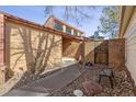 Private front courtyard with brick accent wall and walkway at 3333 E Florida Ave # 108, Denver, CO 80210