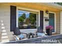 Inviting front porch with chairs and decor, perfect for relaxing and enjoying the neighborhood at 2965 S Gilpin St, Denver, CO 80210