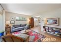 Bright living room featuring hardwood floors, a large window, and stylish furnishings at 2965 S Gilpin St, Denver, CO 80210