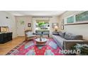 Comfortable living room featuring a stylish rug, ample seating, and natural light at 2965 S Gilpin St, Denver, CO 80210