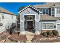 Inviting front entrance with a decorative front door, portico, and manicured landscaping at 10040 Longview Dr, Lone Tree, CO 80124