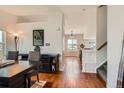 Inviting entryway with hardwood floors, leading to a dining area and staircase at 9651 Bighorn Way, Littleton, CO 80125