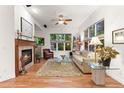 Bright living room boasts a fireplace, plush rug, ceiling fan, and large windows offering natural light at 7444 E 9Th Ave, Denver, CO 80230