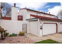 Charming home exterior with red tile roof, attached garage, and wrought iron gate, offering curb appeal at 1321 Madero St, Broomfield, CO 80020