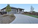 Contemporary home with a long driveway and well-maintained landscaping at 26902 E Ellsworth Ave, Aurora, CO 80018