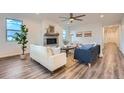 Bright living room with fireplace, modern furniture, and wood floors at 26902 E Ellsworth Ave, Aurora, CO 80018