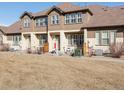 Charming home with seating on the front porch and a well-kept lawn at 5833 S Van Gordon Ln, Littleton, CO 80127