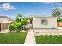 Charming single story home with beautifully maintained lawn and garden area at 1601 S Yates St, Denver, CO 80219