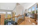 Inviting home entryway featuring hardwood floors, mountain view windows, and decorative railing at 1758 Sinton Rd, Evergreen, CO 80439