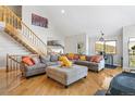 Spacious living room featuring hardwood floors, a comfortable sectional sofa, and natural light from large windows at 1758 Sinton Rd, Evergreen, CO 80439