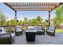 Inviting outdoor living space with comfortable seating, a pergola, and a cozy fire pit at 12189 Windy Trail Ln, Parker, CO 80138