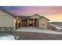 Inviting home with a grand entrance, featuring a stone-accented facade and a spacious driveway at 20201 Royal Troon Dr, Monument, CO 80132