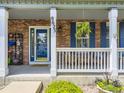 Inviting front porch with brick accents and a blue front door offering a warm welcome at 9625 S Hackberry St, Highlands Ranch, CO 80129