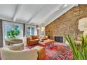 Cozy living room with stone fireplace, vaulted ceilings, and leather sofa at 2496 S Leyden St, Denver, CO 80222