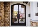 Elegant home featuring a double-door front entry with stone arch and trim at 455 Forest St, Denver, CO 80220