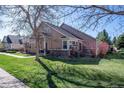 Exterior view showcasing the side of the house with well-maintained lawn and landscaping at 8403 S Miller Ct, Littleton, CO 80127