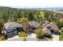 A view of the beautiful neighborhood, surrounded by lush greenery and a golf course, offering a serene setting at 3315 Klondike Pl, Castle Rock, CO 80108