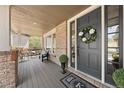 Charming front porch features a welcoming wreath, stylish seating, and an elegant doormat at 3315 Klondike Pl, Castle Rock, CO 80108
