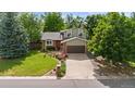 Charming two-story home with a brick facade, lovely landscaping and a two car garage at 5971 Windy St, Golden, CO 80403