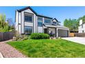 Charming two-story home with a well-maintained front yard and a two-car garage at 8288 W Chestnut Ave, Littleton, CO 80128