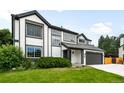 Traditional two-story home with dark trim and a well-kept front lawn at 8288 W Chestnut Ave, Littleton, CO 80128