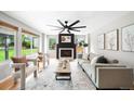 Bright living room with fireplace, large windows, hardwood floors, and neutral decor at 8288 W Chestnut Ave, Littleton, CO 80128