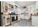 Efficient kitchen with stainless steel oven and stove and vintage farmhouse aesthetic at 27383 Highway 74, Evergreen, CO 80439