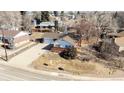 Aerial view of a cozy single-story home with an attached garage in a peaceful residential neighborhood at 343 Melody Dr, Northglenn, CO 80260