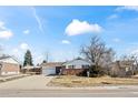 Single-Gathering home with a brick facade, a two-car garage, and a well-maintained lawn at 343 Melody Dr, Northglenn, CO 80260