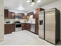 Updated kitchen features wood cabinets, stainless appliances, tile backsplash, and granite counters at 650 S Alton Way # 10A, Denver, CO 80247