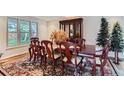 Formal dining room boasting a wooden table, elegant chairs, and a decorative china cabinet at 10165 W Iowa Ave, Lakewood, CO 80232