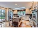 Spacious kitchen with granite countertops, stainless steel appliances, a center island and hardwood floors at 10165 W Iowa Ave, Lakewood, CO 80232