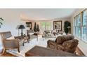 Bright and airy living room featuring neutral tones, plush seating, and large windows for natural light at 10165 W Iowa Ave, Lakewood, CO 80232