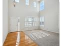 Bright living room with hardwood floors, high ceilings, and large windows at 3587 Vestal Loop, Broomfield, CO 80023