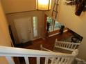 Open foyer with hardwood floors, stairs and a staircase leading to the upper level at 10522 Stoneflower Dr, Parker, CO 80134