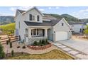 Charming two-story home featuring a three-car garage, inviting porch, and beautiful, low-maintenance landscaping at 5446 Mesa Top Dr, Monument, CO 80132