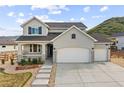 Charming two-story home featuring a three-car garage, inviting porch, and beautiful, low-maintenance landscaping at 5446 Mesa Top Dr, Monument, CO 80132
