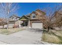 Beautiful home with a well-manicured lawn and a spacious driveway leading to a two-car garage at 6852 S Algonquian Ct, Aurora, CO 80016