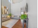 Bright living room with hardwood floors, high ceilings, stylish decor, and comfortable seating at 6852 S Algonquian Ct, Aurora, CO 80016