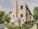 Multi-story exterior showcasing well-maintained landscaping, and individual unit balconies on a partly cloudy day at 4068 S Atchison Way # 101, Aurora, CO 80014