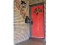 Stylish red front door with decorative window and distinctive hardware at 1363 Stuart St, Denver, CO 80204