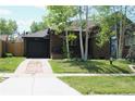 Brick home featuring a front yard, driveway, and a cozy front porch at 1363 Stuart St, Denver, CO 80204