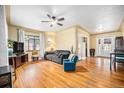 Bright living room featuring hardwood floors, large windows, and a ceiling fan at 1363 Stuart St, Denver, CO 80204