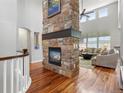 Inviting living room with hardwood floors, stone fireplace, and lots of natural light at 15264 W La Salle Ave, Lakewood, CO 80228