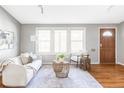 Inviting living room with large windows, hardwood floors, and a cozy seating area, perfect for relaxation at 375 Coral St, Broomfield, CO 80020