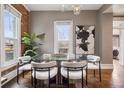 Bright dining room with a glass-top table and stylish upholstered chairs at 321 S Emerson St, Denver, CO 80209